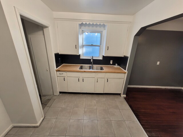 15836 Patton St, Detroit, MI 48223 - kitchen featuring a sink, white cabinets, wood counters, and light tile patterned flooring