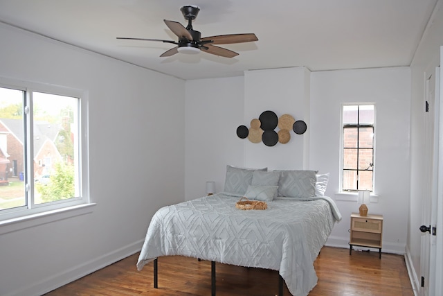 bedroom with hardwood / wood-style flooring and ceiling fan