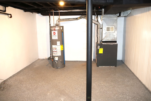 basement featuring gas water heater and heating unit