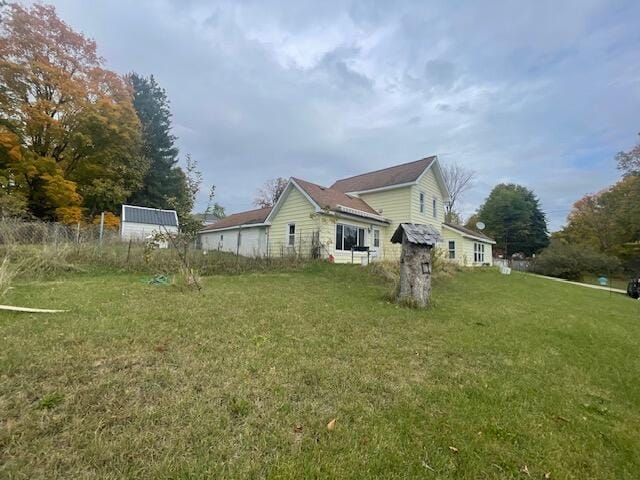 view of side of home featuring a lawn