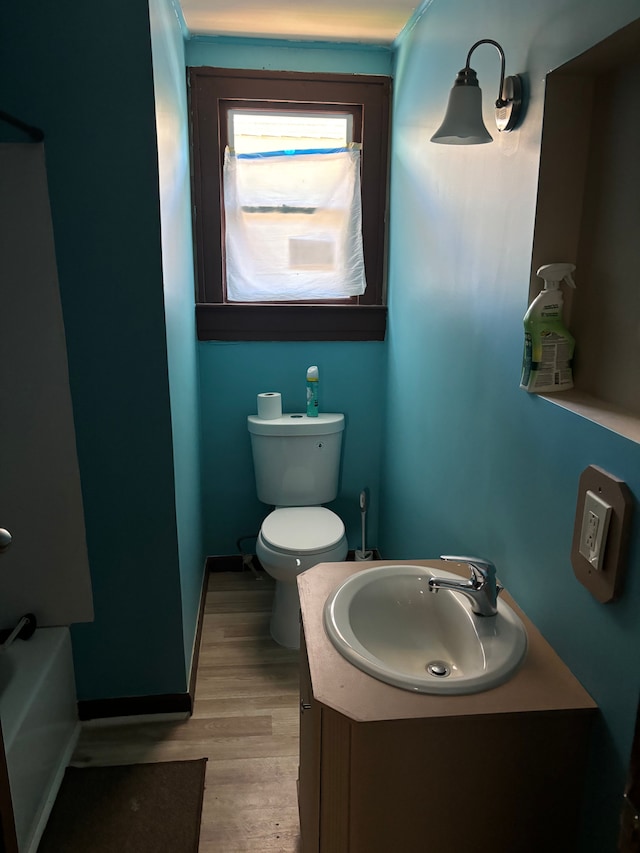 full bathroom featuring vanity, toilet, and wood finished floors