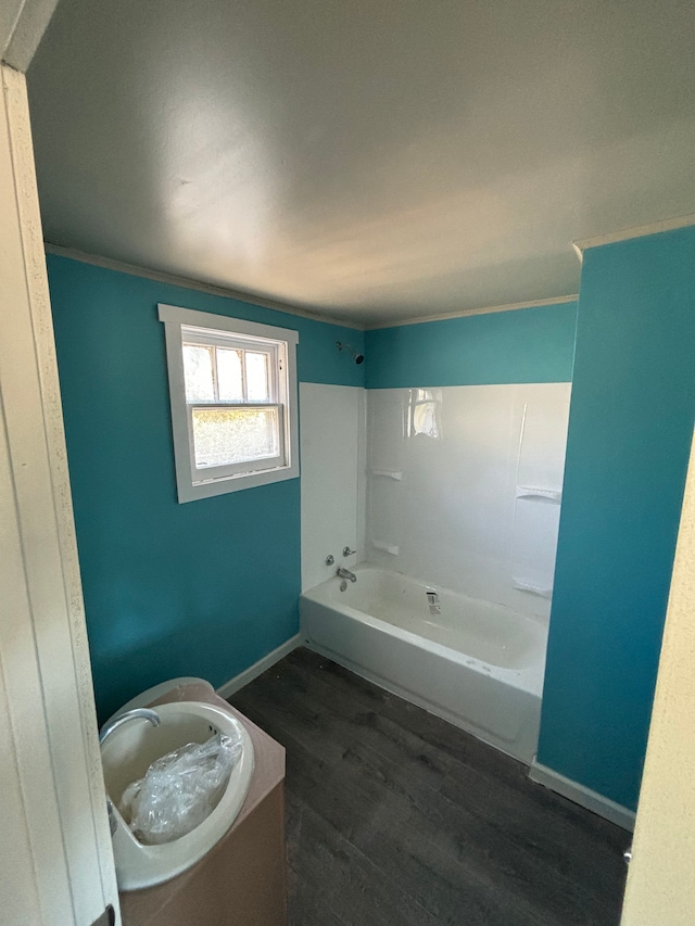 full bath with crown molding, shower / tub combination, baseboards, and wood finished floors