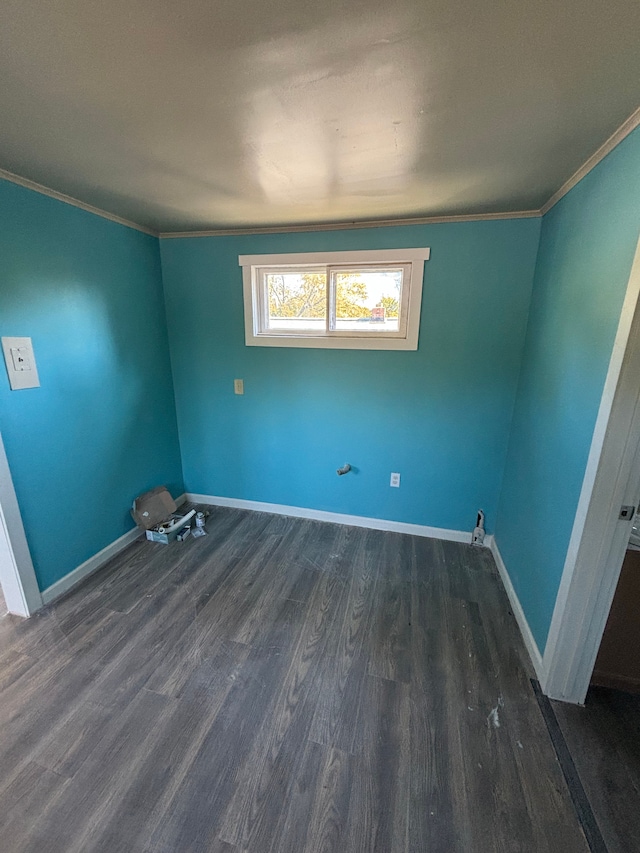 empty room with dark wood-type flooring and crown molding