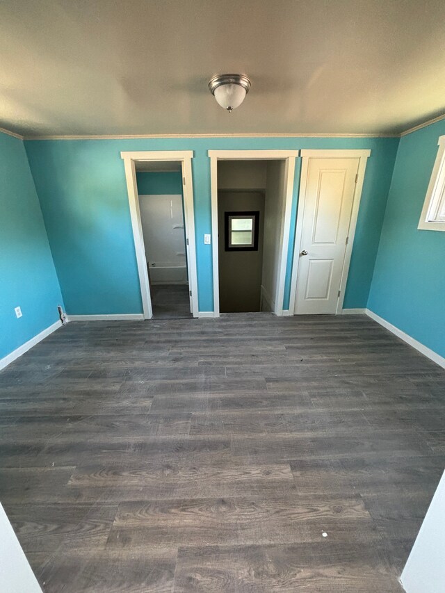 unfurnished bedroom with dark hardwood / wood-style flooring