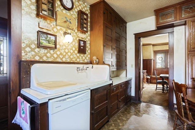 kitchen with a textured ceiling and white dishwasher