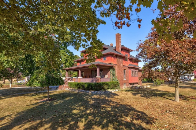 view of home's exterior featuring a lawn and covered porch