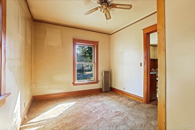 carpeted empty room featuring ceiling fan, radiator heating unit, crown molding, and a textured ceiling