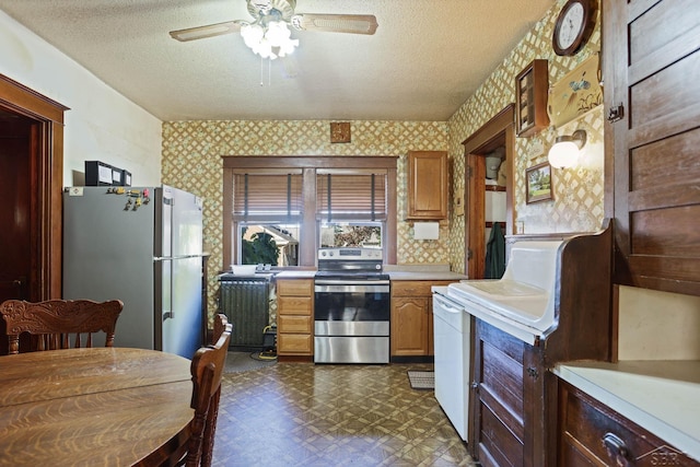 kitchen featuring ceiling fan, stainless steel appliances, and a textured ceiling