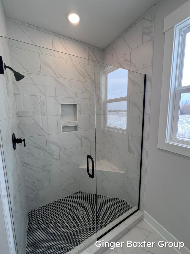 bathroom featuring a shower with shower door