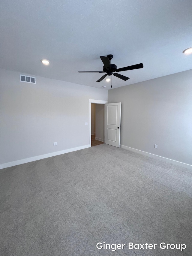 empty room with carpet floors and ceiling fan