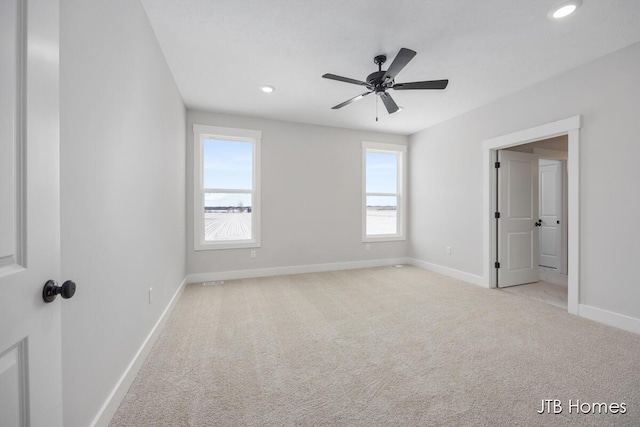 unfurnished bedroom featuring recessed lighting, baseboards, and light colored carpet