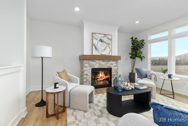 11376 Shoreline Dr Unit 115, Allendale, MI 49401 - sitting room with baseboards, a stone fireplace, light wood finished floors, and recessed lighting