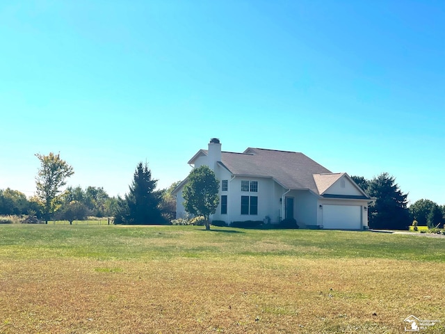 view of front of property with a front lawn and a garage