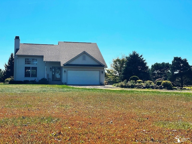 view of front of house with a garage and a front lawn