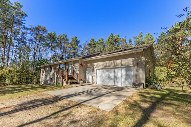 ranch-style home with a garage and a front lawn