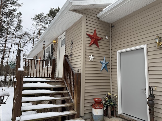 view of snow covered property entrance