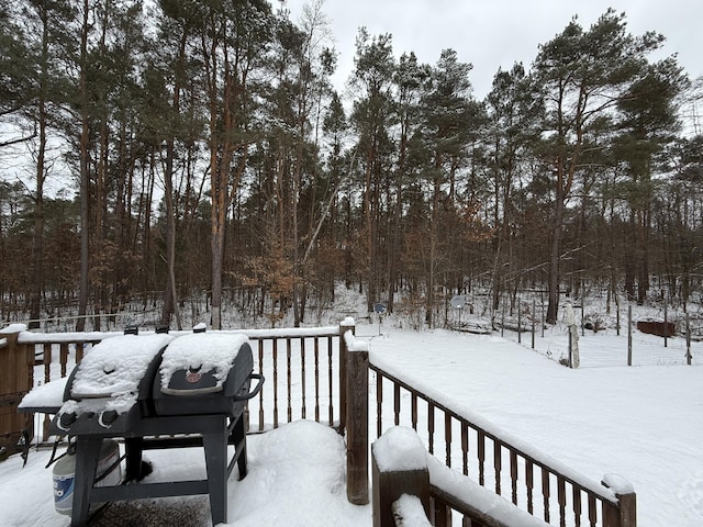 snow covered deck featuring a grill