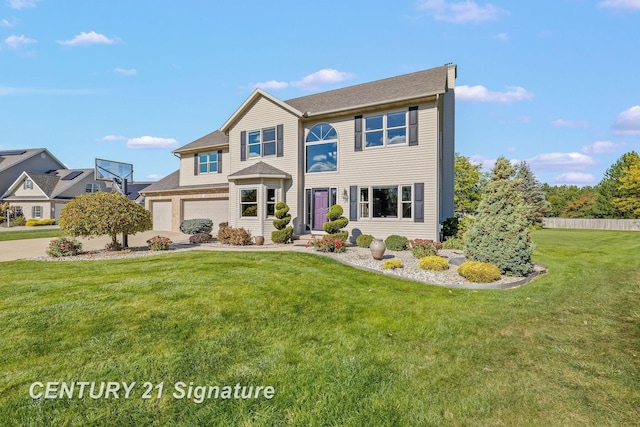 view of front of house featuring a front yard and a garage