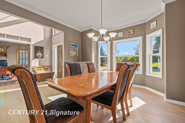 dining space featuring a chandelier, light hardwood / wood-style flooring, and ornamental molding