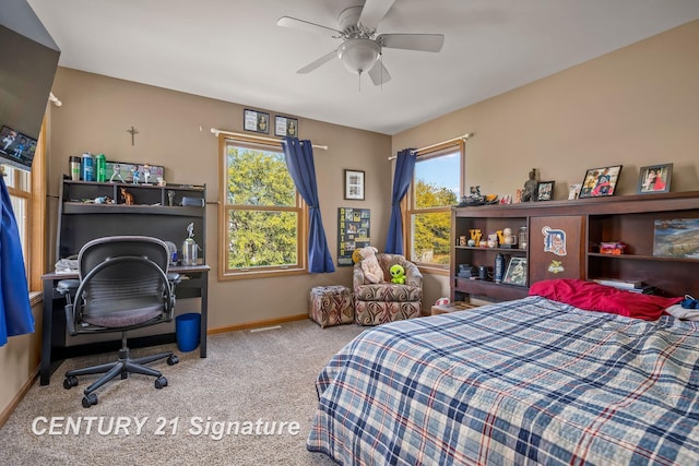 carpeted bedroom featuring multiple windows and ceiling fan