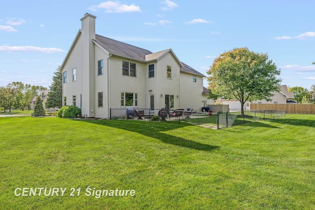 rear view of property with a lawn