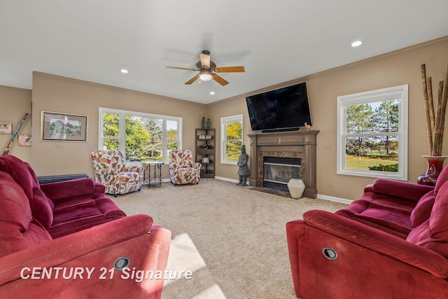 living room featuring a high end fireplace, carpet floors, plenty of natural light, and ceiling fan