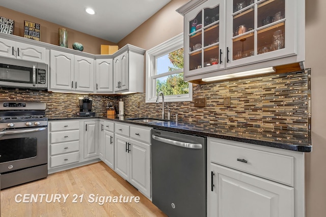 kitchen with white cabinetry, sink, and stainless steel appliances