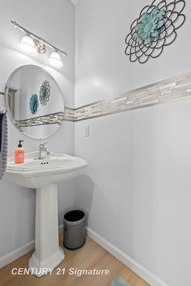 bathroom with hardwood / wood-style floors