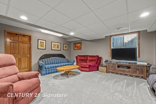 living room with a paneled ceiling and carpet floors