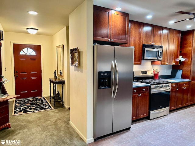 kitchen featuring ceiling fan, light colored carpet, and appliances with stainless steel finishes