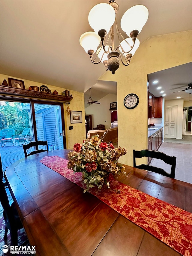 dining area with ceiling fan with notable chandelier