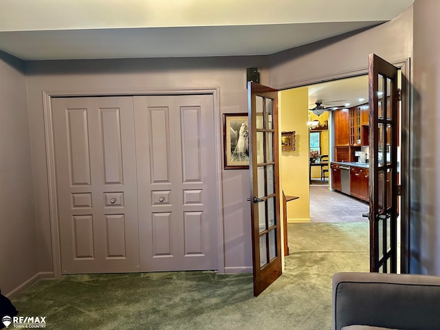 corridor featuring light carpet and french doors