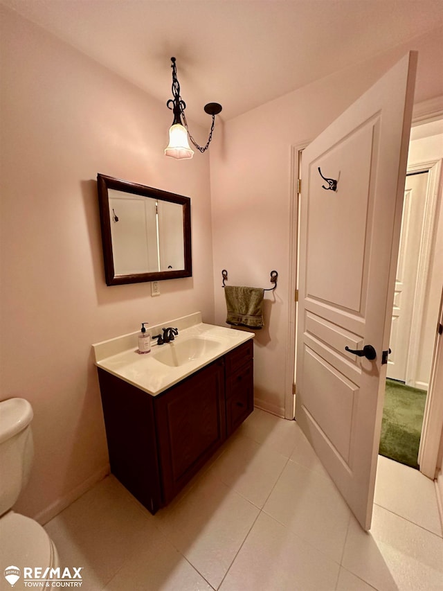 bathroom featuring tile patterned floors, vanity, and toilet