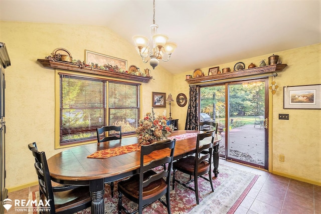 dining area featuring tile patterned floors, an inviting chandelier, and vaulted ceiling