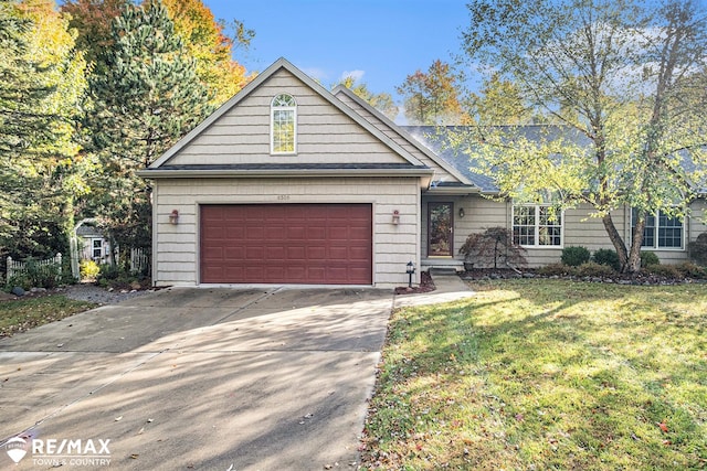 view of front of house featuring a front lawn and a garage