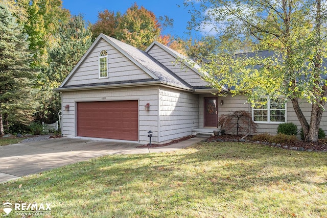 view of front of property with a garage and a front lawn