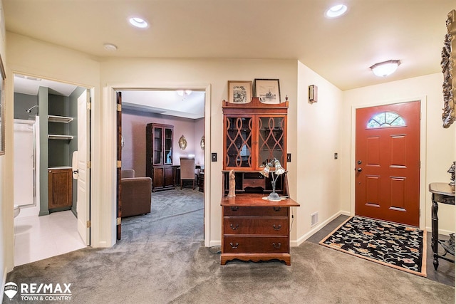 foyer with carpet flooring