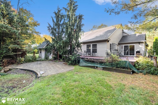 back of house featuring a patio area and a yard