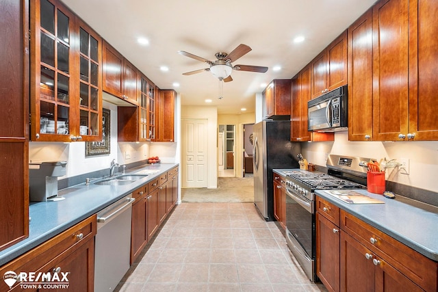 kitchen with appliances with stainless steel finishes, ceiling fan, and sink