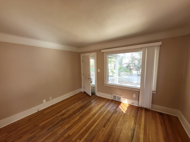 empty room with dark hardwood / wood-style flooring