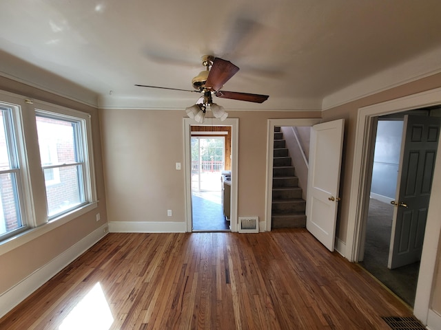 spare room featuring a wealth of natural light, ceiling fan, and hardwood / wood-style flooring