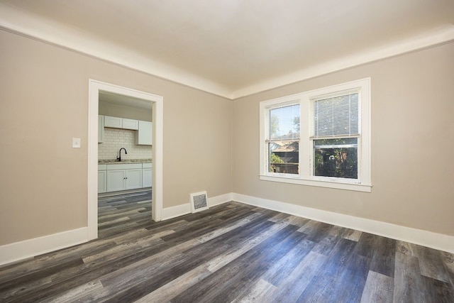 spare room featuring dark hardwood / wood-style floors and sink