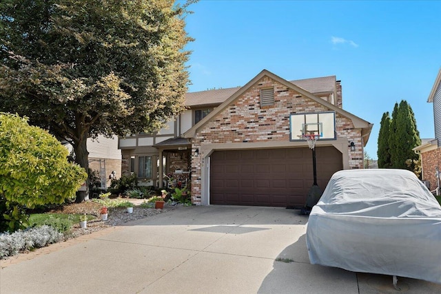 view of front of home featuring driveway, brick siding, and an attached garage