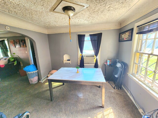 carpeted dining area featuring cooling unit and a textured ceiling