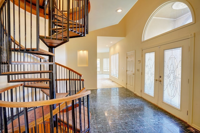 foyer entrance with french doors and a high ceiling