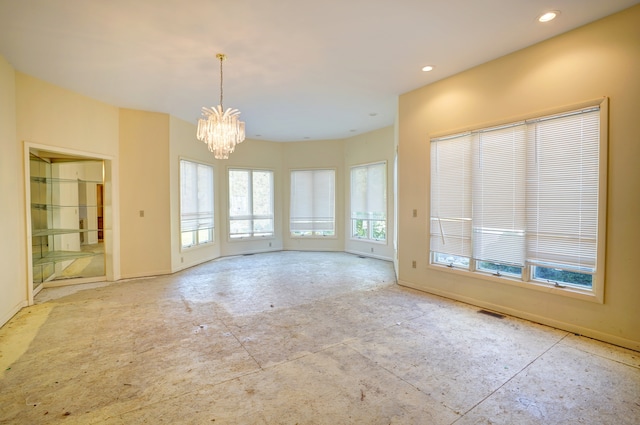 unfurnished room with a chandelier