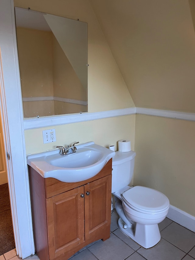 bathroom featuring tile patterned flooring, vanity, and toilet