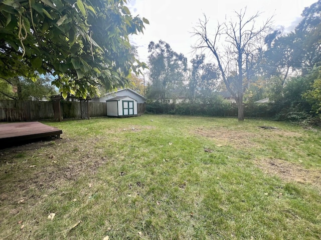 view of yard featuring a shed and a deck