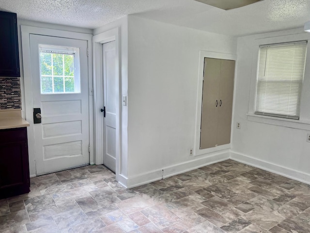 entryway featuring a textured ceiling