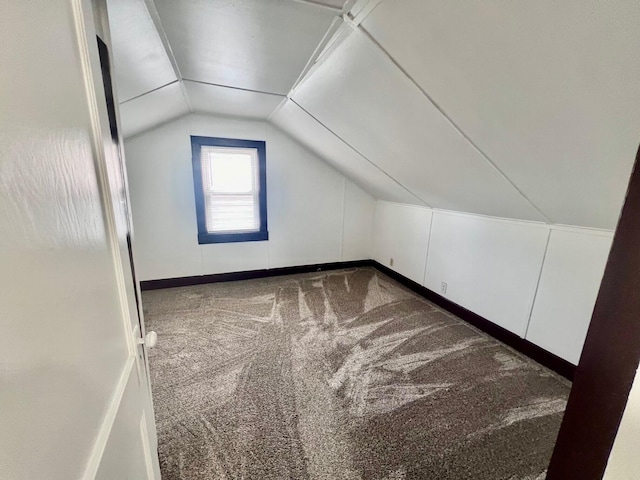 bonus room with carpet and vaulted ceiling